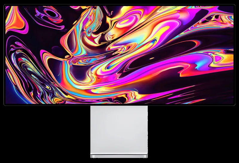 Kuycon W34KB-monitor op een zwarte achtergrond met sterk verzadigde wervelingen in roze, oranje, geel en blauw, ter illustratie van de rijkdom aan kleuren